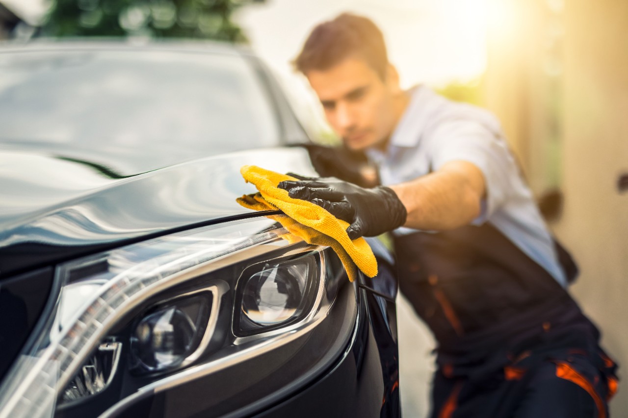 Man Cleaning Car with Microfiber Cloth
