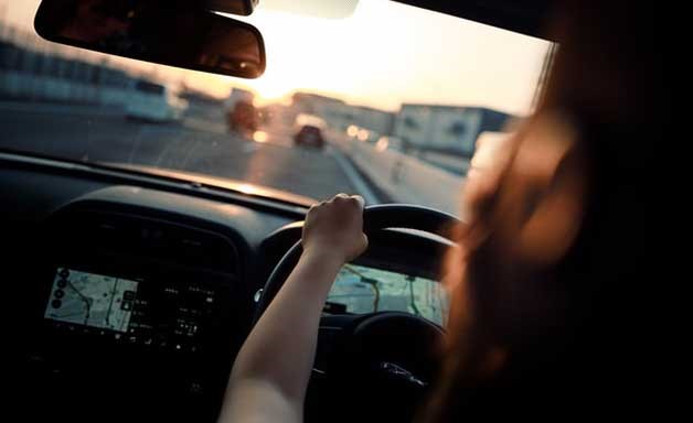 woman on the car steering wheel