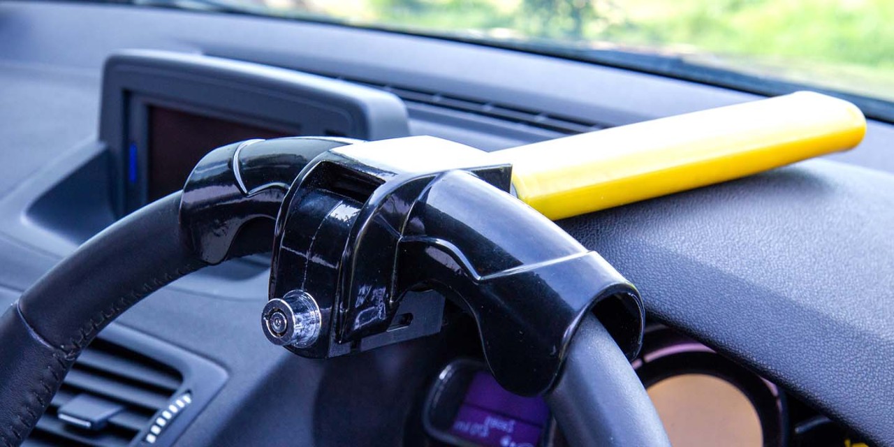 Steering wheel lock bar locked on a vehicle steering wheel 