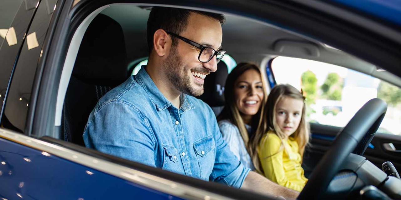 smiling man driving car
