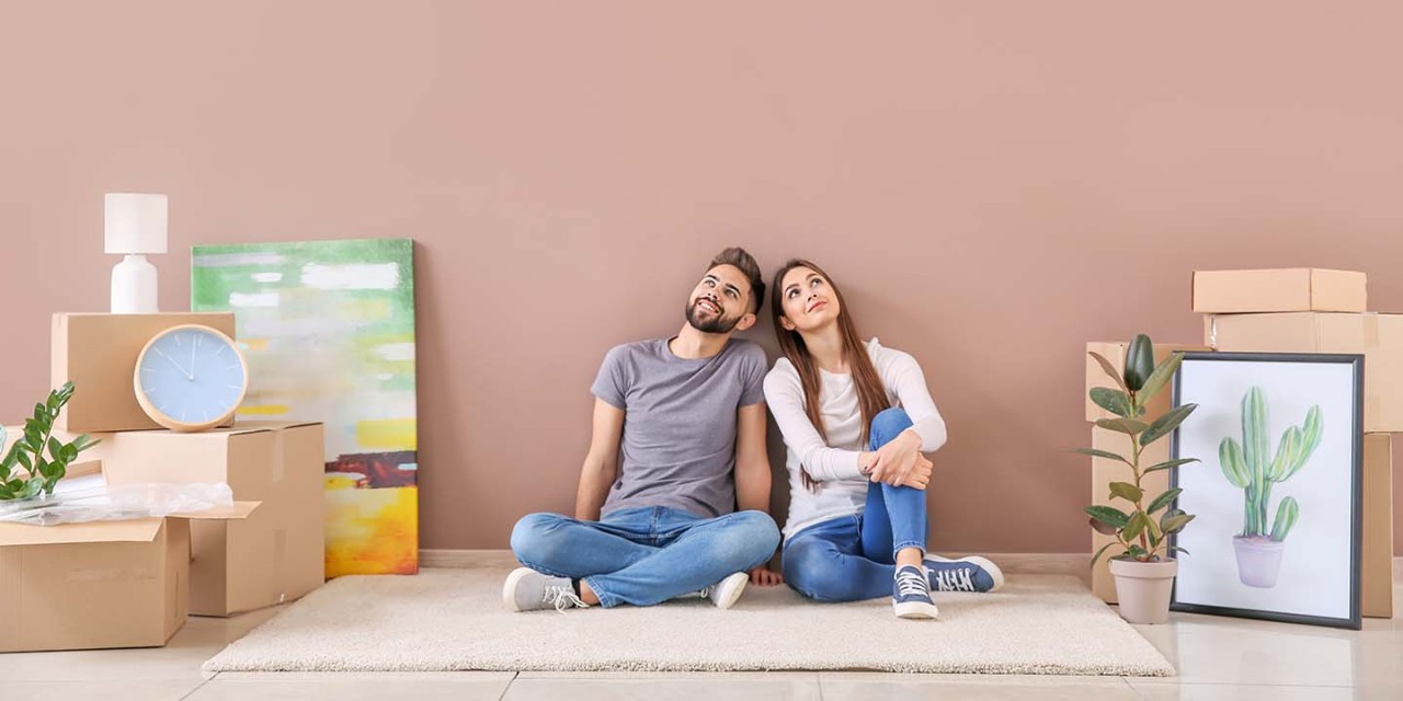  happy couple with moving boxes