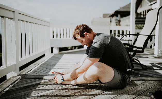 man stretching on the balcony 