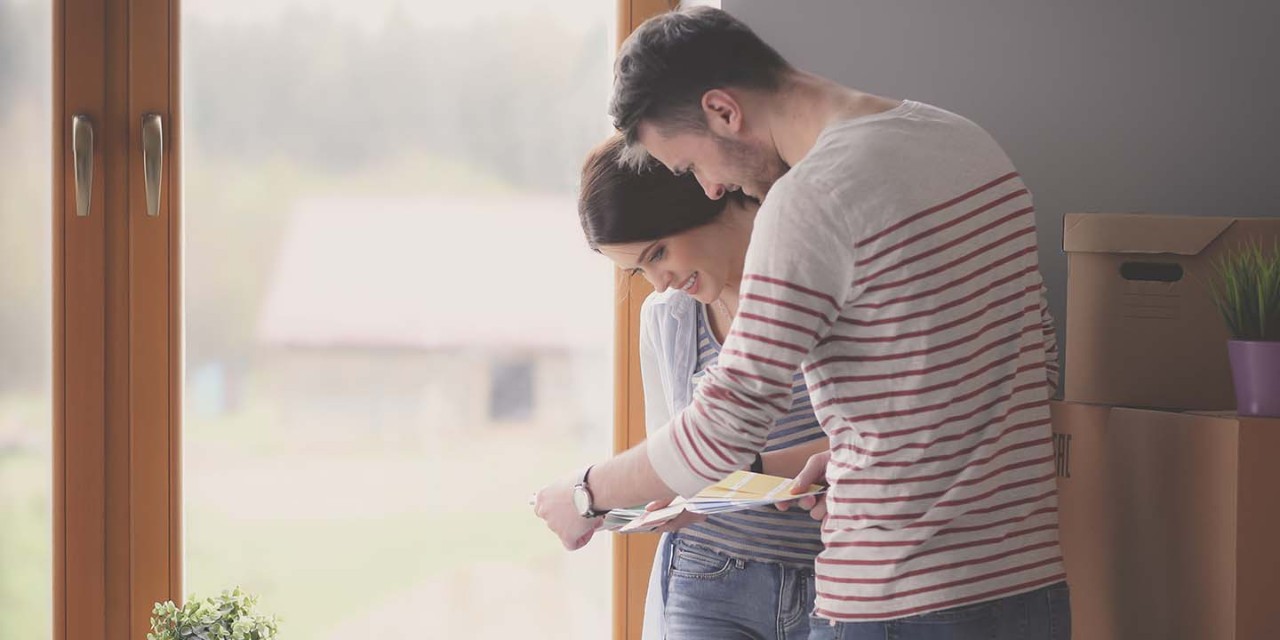 smiling couple looking at the contract of new house