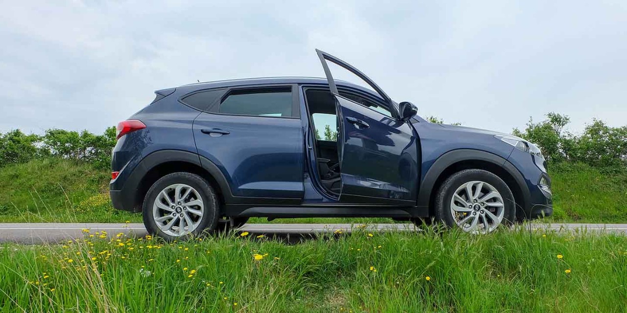  a car with door opening on the country road