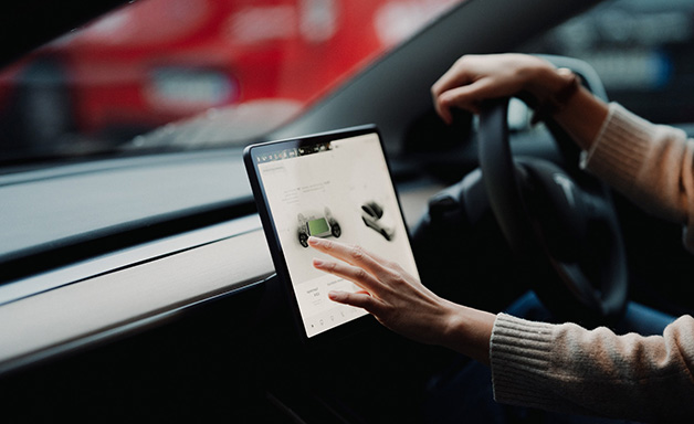 close up of hand adjusting navigation system on car