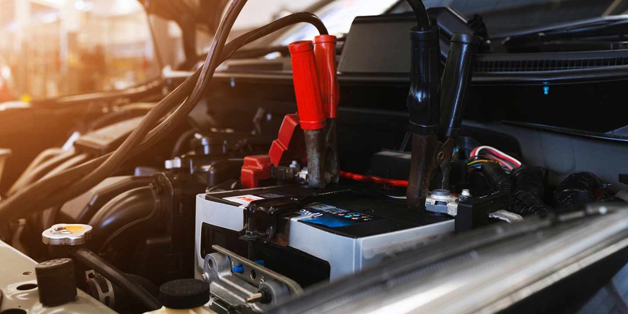  closeup charging car battery with electricity through jumper cables