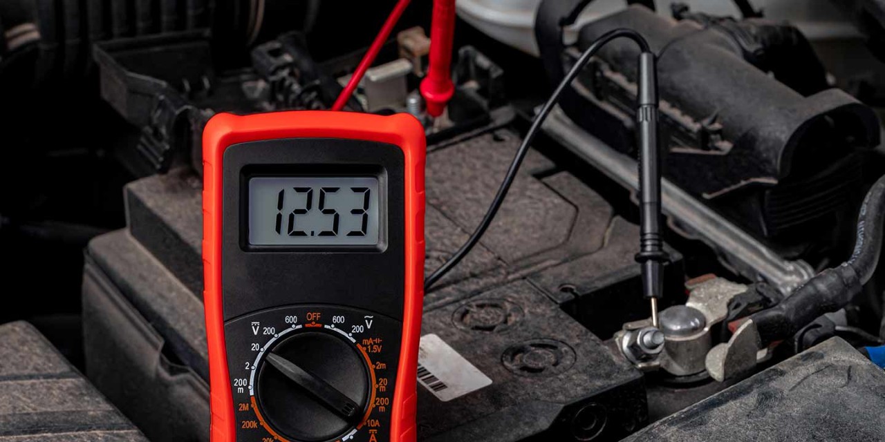 Battery tester checking car battery voltage