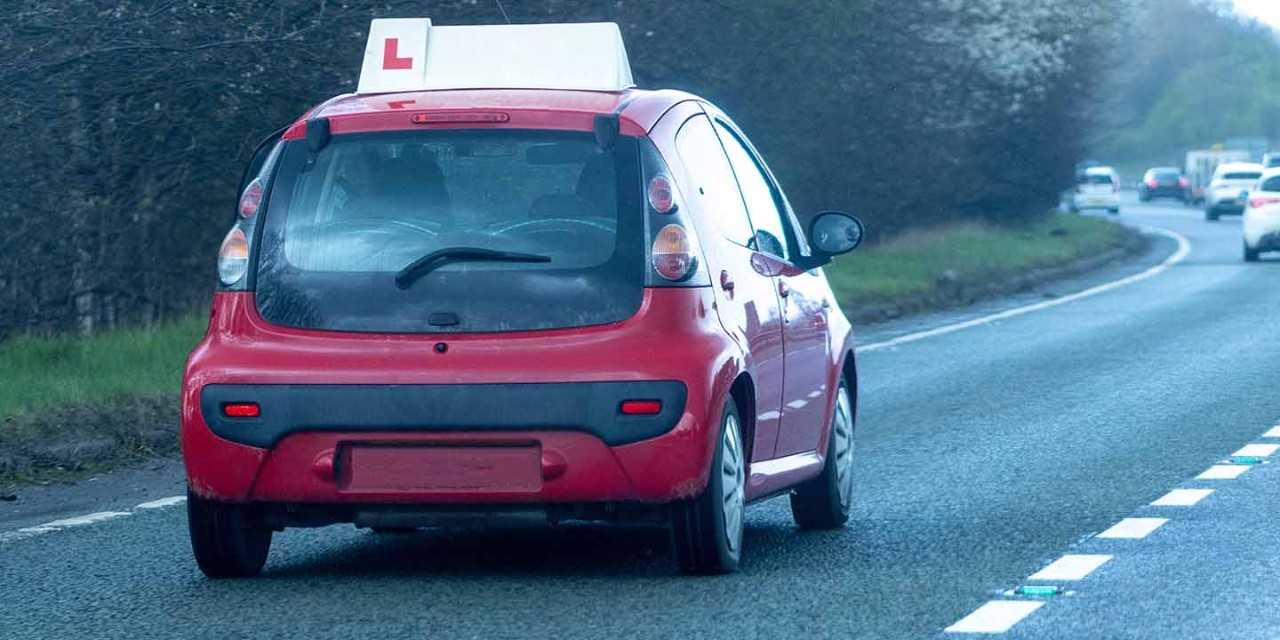  L plate on the red car 