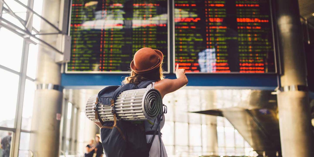  Woman backpack looking flight timetable board