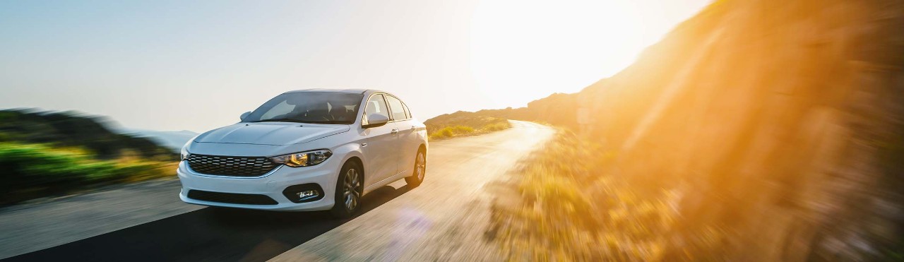  driving car under sunset