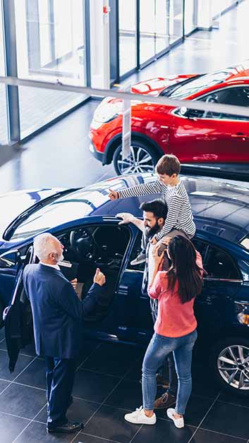 family buying car at a car dealer