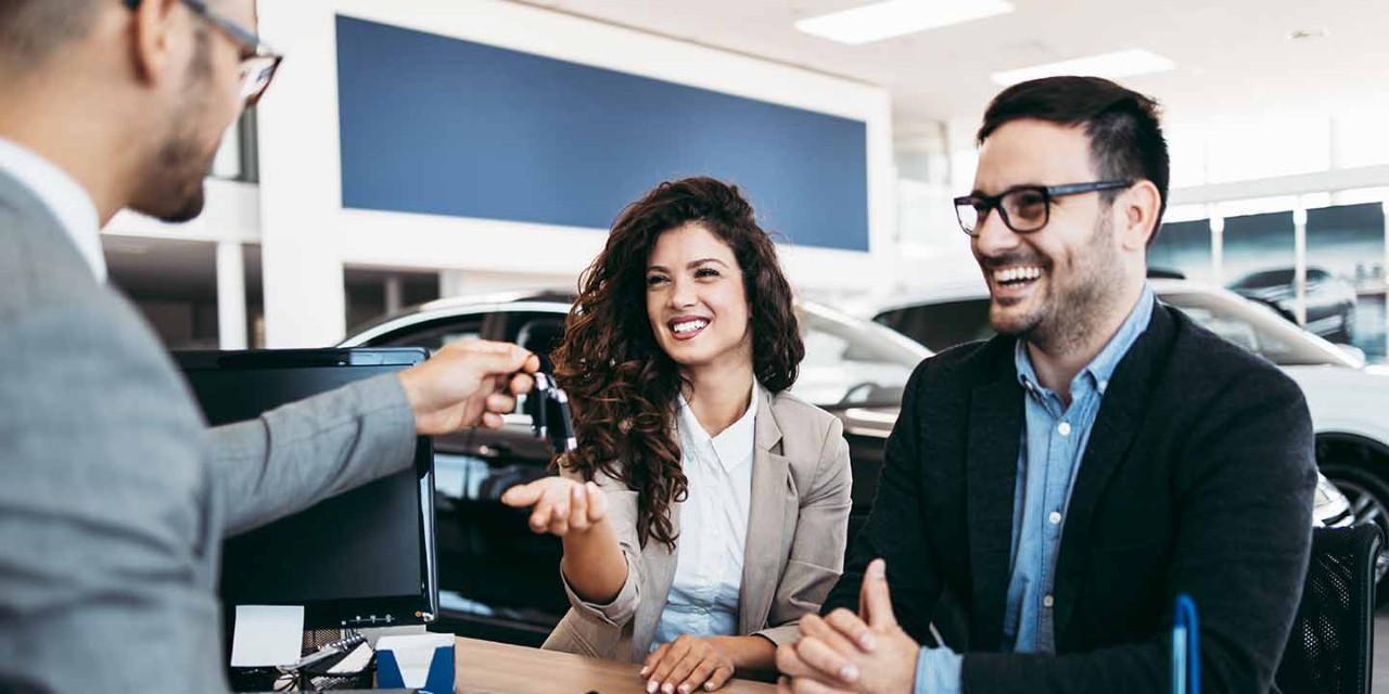 young couples smiling to get the car key