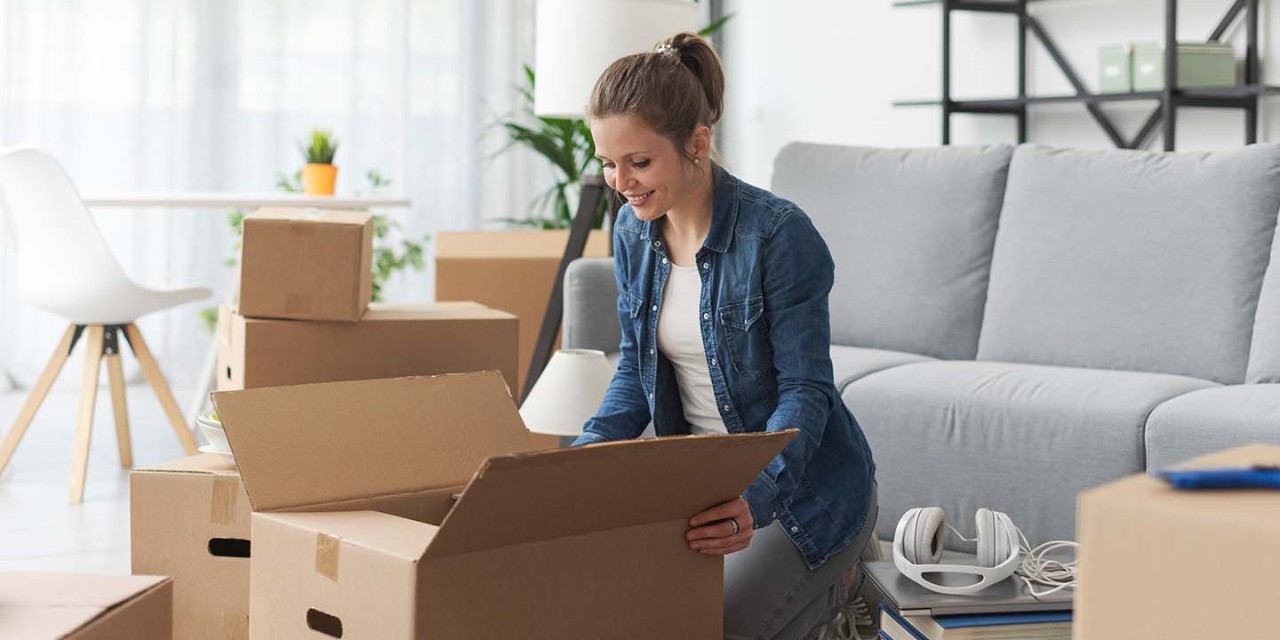  woman opening a cardboard box