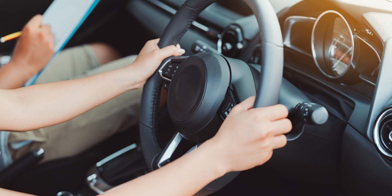  hands on car wheel