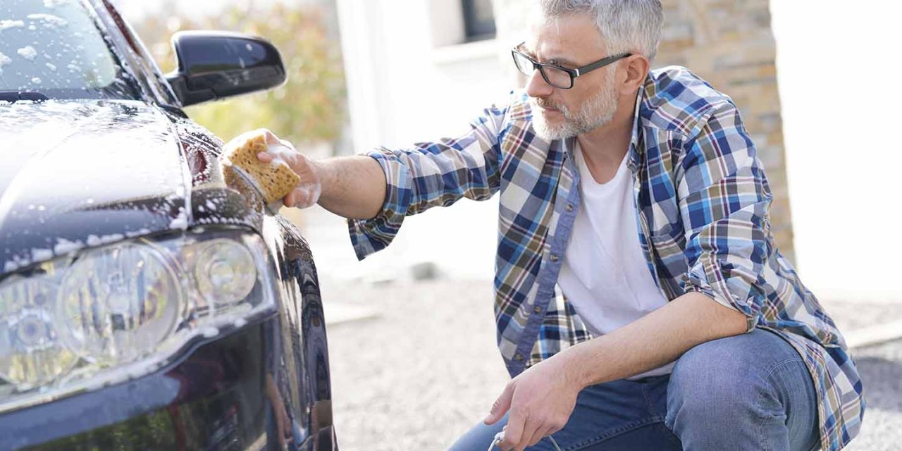 old man washing a car 