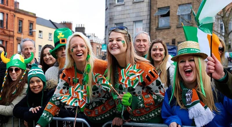 Women smiling on St. Patrick's Day parade
