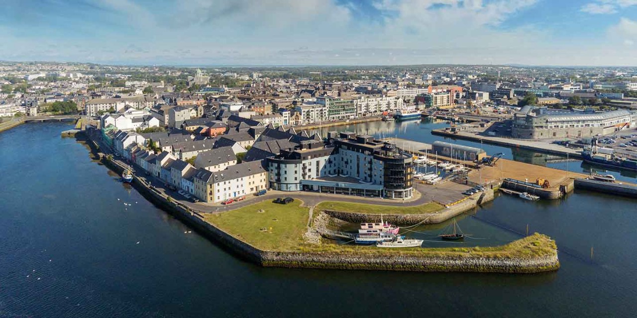 Aerial view on Galway city, river Corrib, Claddagh area, Sunny day, Cloudy sky.