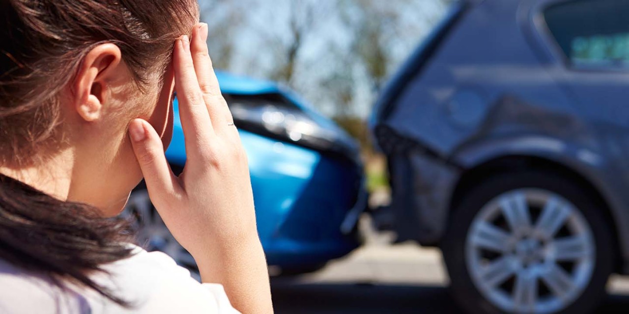 Woman in front  of a car crash