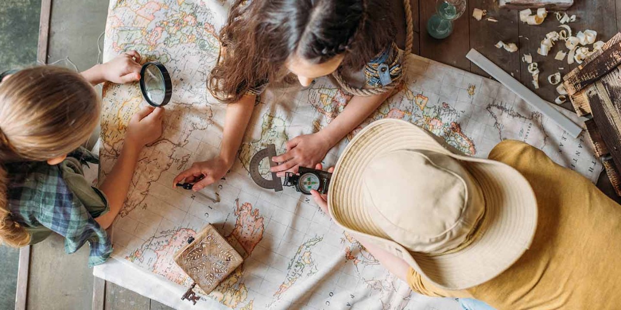  kids playing with the world map