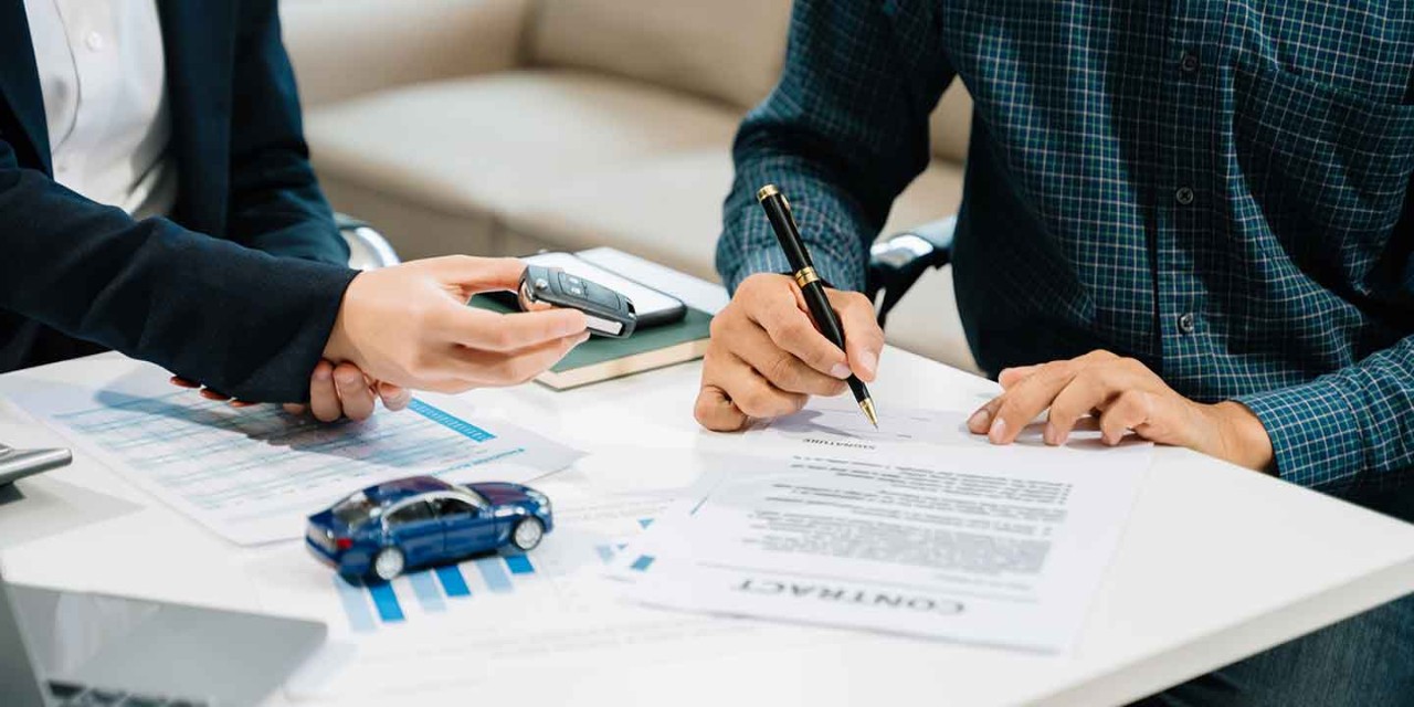 car sale agreement with paperwork and model car
