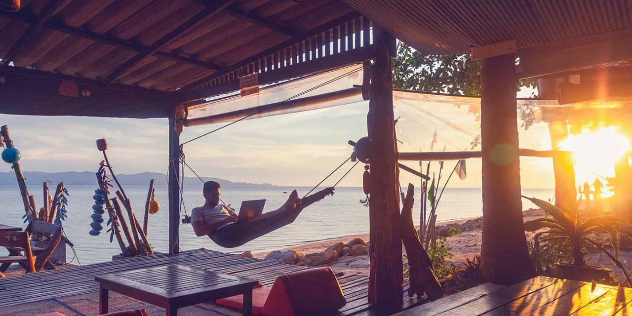 Man working remotely from hammock