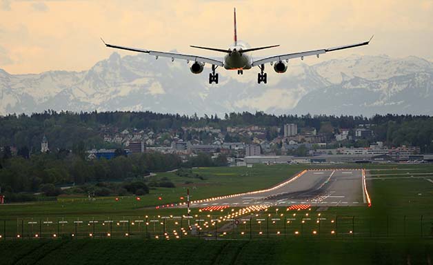 passenger airplane landing on runway in airport evening
