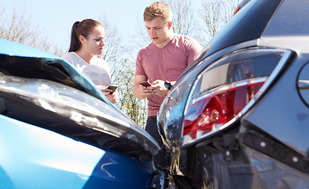 Two Drivers Exchange Insurance Details After Car Accident