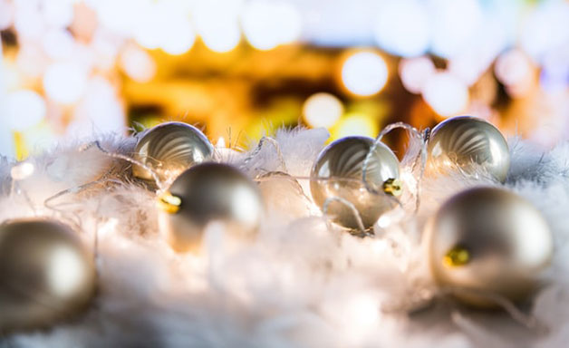 Christmas white decorations on snow with Christmas lights. 