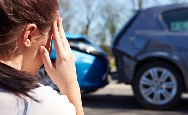 woman standing in front of a car accident