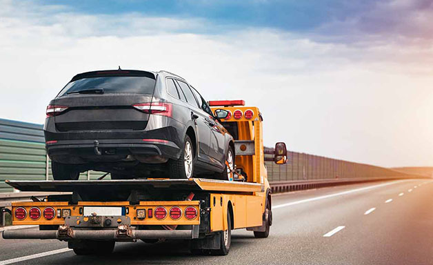 Recovery truck to transport a car on the highway in the city