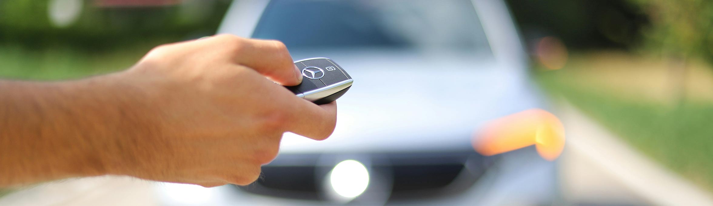 car key on hand opening the car