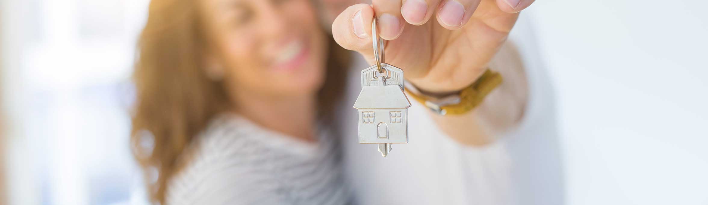  happy couple with home key in hand